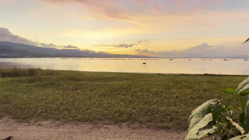 Sunset Over Calm Lake With Distant Mountains