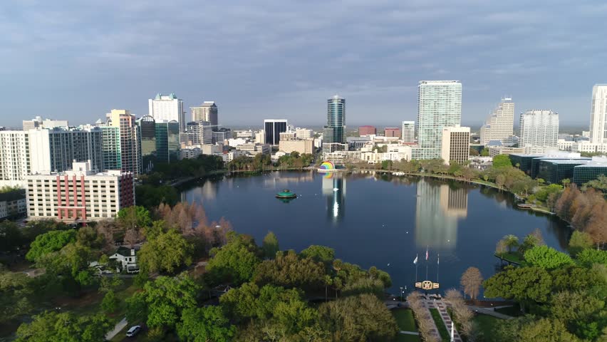 "Aerial view of Lake Eola Park and downtown Orlando, showcasing scenic water, city skyline, and the harmonious blend of urban and natural landscapes."