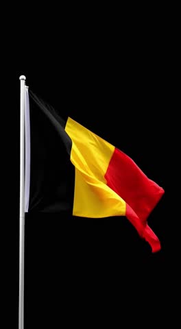 Belgium flag on a pole floating in the wind isolated on black background