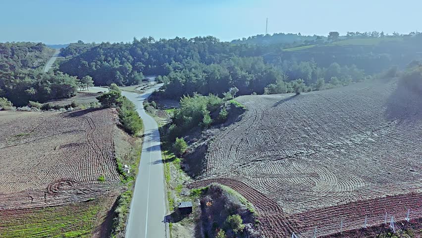 Rural landscape with winding road and cultivated farmlands in countryside