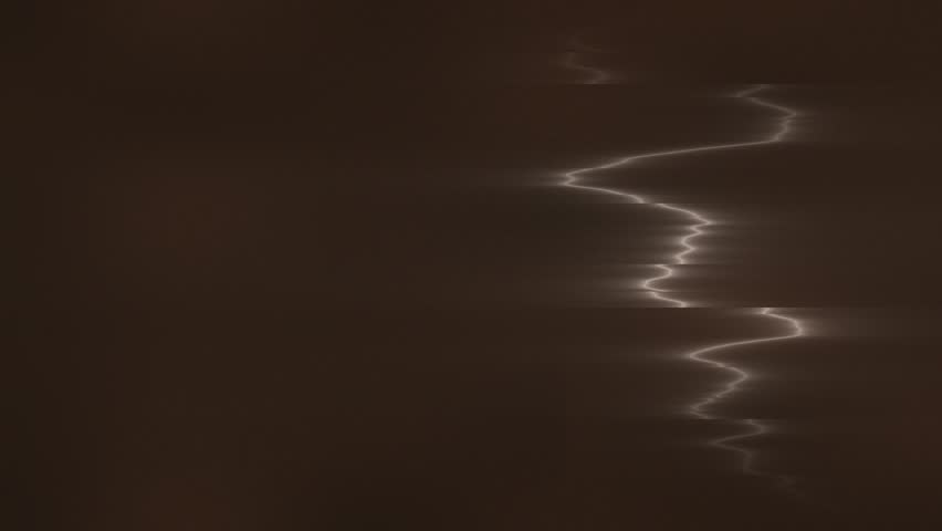 Electrical storm with bright jagged lightning striking through a dark sky.