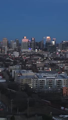 Apartment Buildings And Downtown Nashville Skyline At Blue Hour In Tennessee, USA, Vertical Aerial Flyover