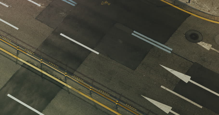 Vehicles traverse an urban street, highlighting the continuous flow of traffic with visible lane markings and blurred motion effects. Time-lapse, Seoul, South Korea