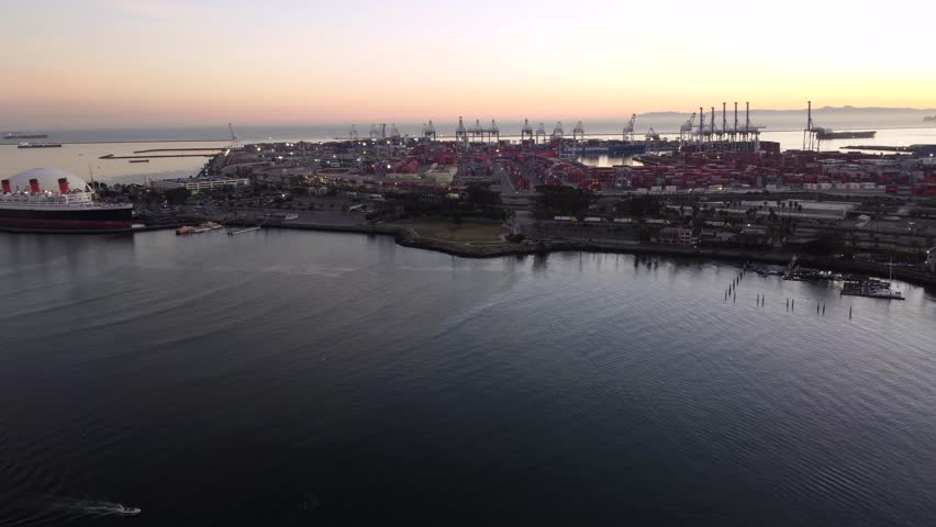 Los Angeles Port shipping industrial port dock for import export of Global Trade. Ships waiting to dock, trains and semi trucks waiting to be unloaded and loaded.