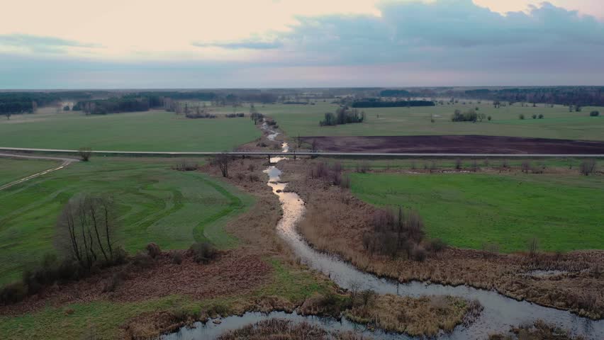 Bridge over Belczac river, branch of the Liwiec river near Paplin village in Masovian Voivodeship of Poland, 4k video