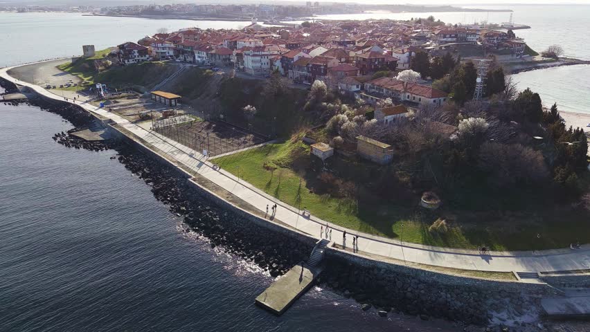 Aerial view of the city of Nessebar with parks and houses built up streets with people walking in Black Sea, Bulgaria