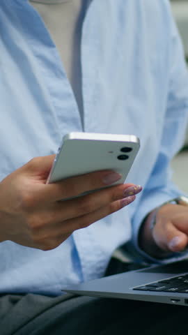 Multitasking African American business woman working laptop mobile phone city outside office female entrepreneur typing computer businesswoman holding smartphone chatting online technology freelance