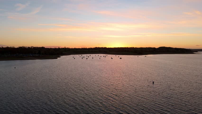 Aerial Drone View of Yachts and Boats Moored in Harbour at Rutland Water Reservoir During Golden Winter Sunset