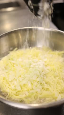 The cook prepares dough for the national Polish dish placki ziemniaczane (potato pancakes). 