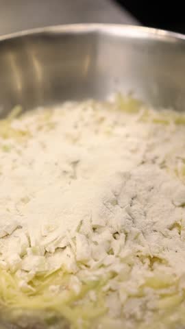 The cook prepares dough for the national Polish dish placki ziemniaczane (potato pancakes). 