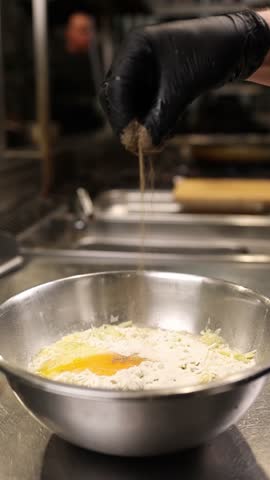 The cook prepares dough for the national Polish dish placki ziemniaczane (potato pancakes). 