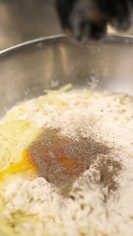The cook prepares dough for the national Polish dish placki ziemniaczane (potato pancakes). 