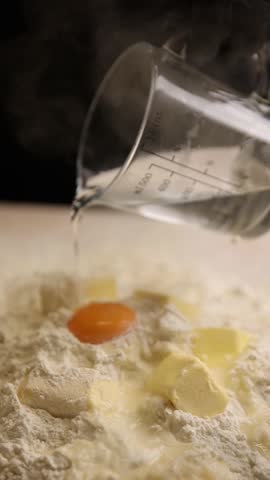 The cook in the kitchen is preparing dough for dumplings.