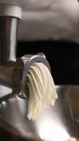 The cook in the kitchen prepares the filling for the dumplings.
