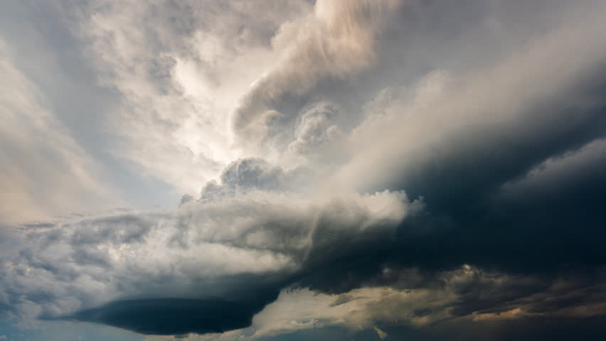 Powerful thunderstorm clouds build high into the atmosphere, forming a beautiful dark storm with towering structure, deep shadows, and dramatic textures that highlight the intensity and scale of severe weather conditions