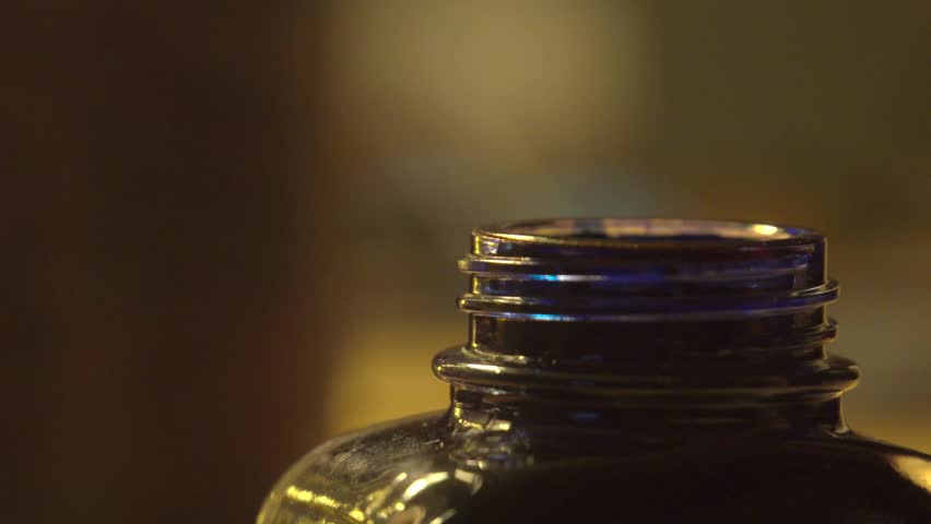 Close-up cinematic shot of a vintage fountain pen writing on aged parchment paper. Black ink flows smoothly from the nib, forming elegant cursive letters. Retro aesthetic, warm sepia tones, soft film