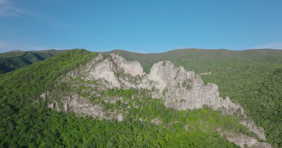 Aerial sweep ascend over Seneca Rocks, rugged peaks and Appalachian terrain, West Virginia