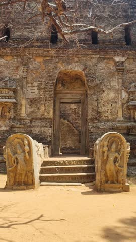 Vertical shot of the ruins of Lankatilaka Vihara, a 12th-century Buddhist monastery complex in Polonnaruwa, Sri Lanka, showcasing historic architecture and ancient stone structures