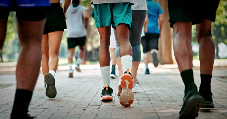 Legs, people and marathon competition in nature for fitness challenge, sport event and running. Runners, shoes of group and race contest at park for endurance test, jogging pace or cardio performance