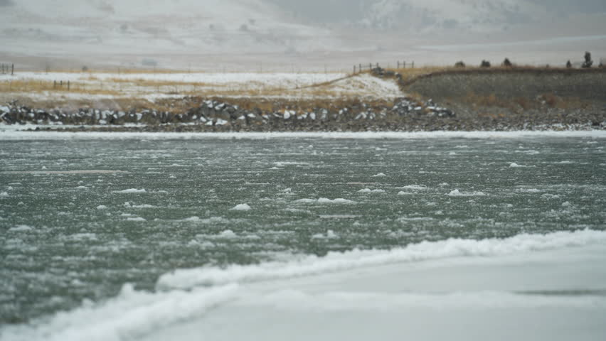 Low angle view of ice flowing down Montana river