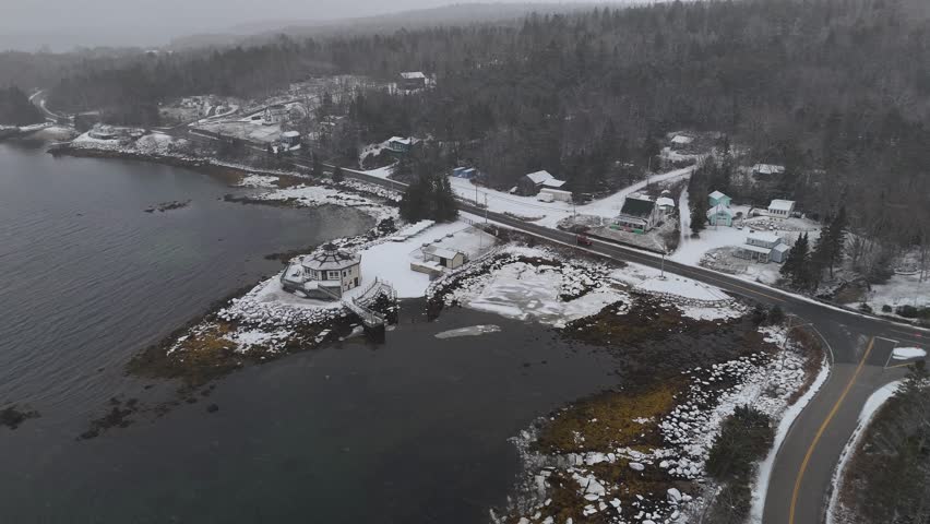 Aerial view of a small waterfront town in Nova Scotia Canada during a winter snow storm