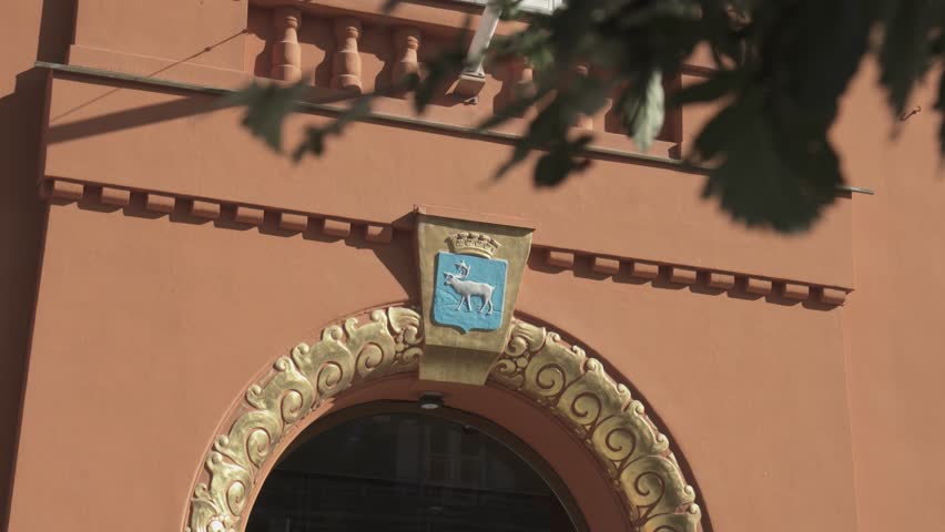 Coat Of Arms Displayed On The Facade Of Rodbanken Building In Tromso, Norway. - handheld shot