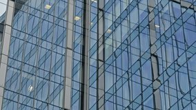Reflections on a modern glass skyscraper facade, with distorted patterns of neighboring towers across vertical window grids and mullions, capturing urban geometry and abstraction - Powered by Shutterstock - Get 15% off with code: PIKWIZARD15