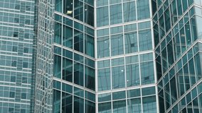 Close-up view of intersecting glass facades on modern office skyscrapers, showcasing reflective curtain wall windows, geometric grid patterns, and sleek urban architecture. - Powered by Shutterstock - Get 15% off with code: PIKWIZARD15