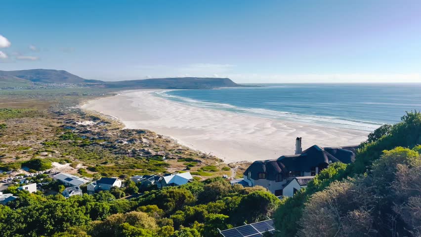 Aerial views of the Cape Peninsula in South Africa featuring dramatic Atlantic coastline, Chapman’s Peak Drive, Noordhoek Beach, Cape Point and the Cape of Good Hope. The footage showcases rugged cliffs, white sand beaches, turquoise ocean water and rolling mountains within Table Mountain National Park.

Filmed in bright summer daylight, the video captures scenic coastal roads, panoramic viewpoints, coastal fynbos vegetation and powerful waves meeting rocky shorelines. This iconic region at the southwestern edge of the African continent is known for its biodiversity, unspoiled landscapes and spectacular seascapes, making it ideal for travel, tourism, nature and adventure productions.
