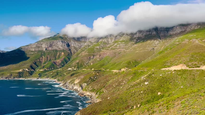 Aerial views of the Cape Peninsula in South Africa featuring dramatic Atlantic coastline, Chapman’s Peak Drive, Noordhoek Beach, Cape Point and the Cape of Good Hope. The footage showcases rugged cliffs, white sand beaches, turquoise ocean water and rolling mountains within Table Mountain National Park.

Filmed in bright summer daylight, the video captures scenic coastal roads, panoramic viewpoints, coastal fynbos vegetation and powerful waves meeting rocky shorelines. This iconic region at the southwestern edge of the African continent is known for its biodiversity, unspoiled landscapes and spectacular seascapes, making it ideal for travel, tourism, nature and adventure productions.