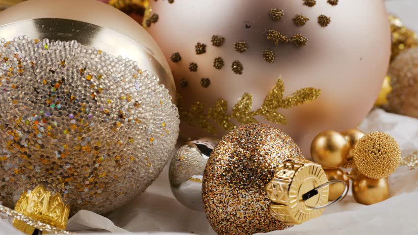 Holiday spirit background. Golden Christmas decorations. Festive white backdrop.