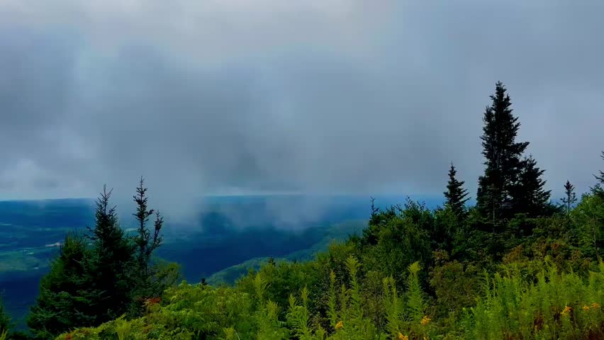 Misty mountaintop with aerial view of below
