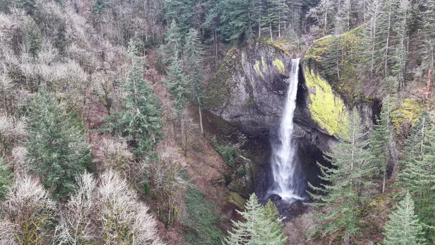 On windy, winter day, the beautiful Latourell Falls flows into the Columbia River Gorge in Oregon. This scenic, forested area, full of hiking trails and vistas, is not far from Portland.