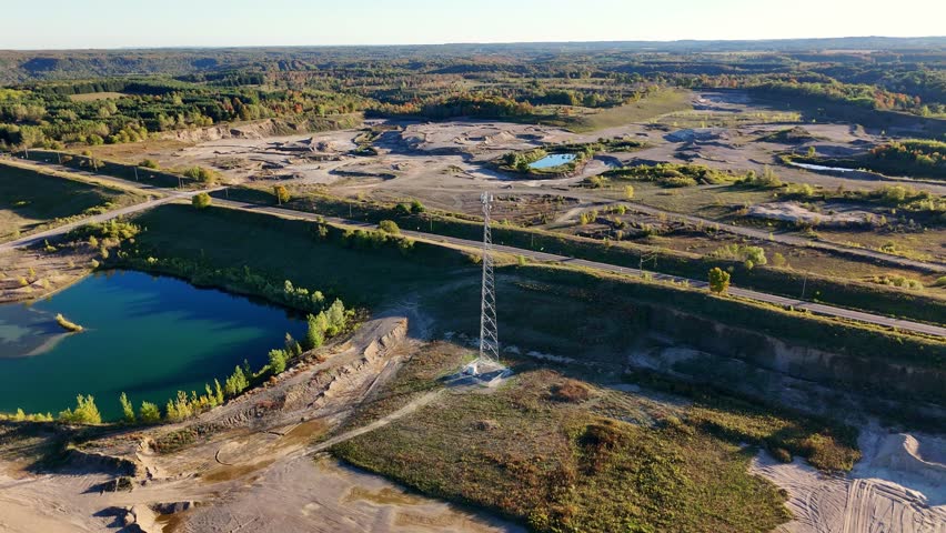 Aerial View of Telecommunication Tower in Gravel Quarry Landscape