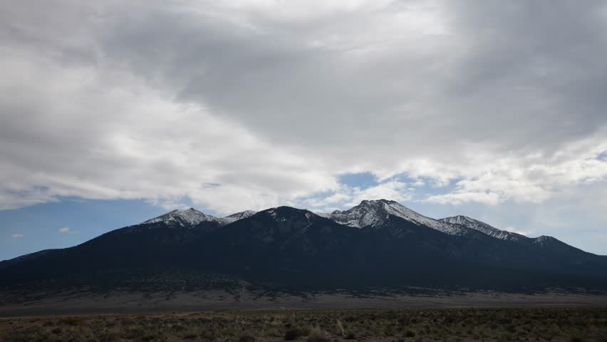 mountains white clouds desert perspective Colorado southern Colorado snow capped mountains blue sky shadow