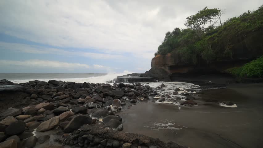 Epic crashing oceanic waves in rocky coastal shore in slow motion