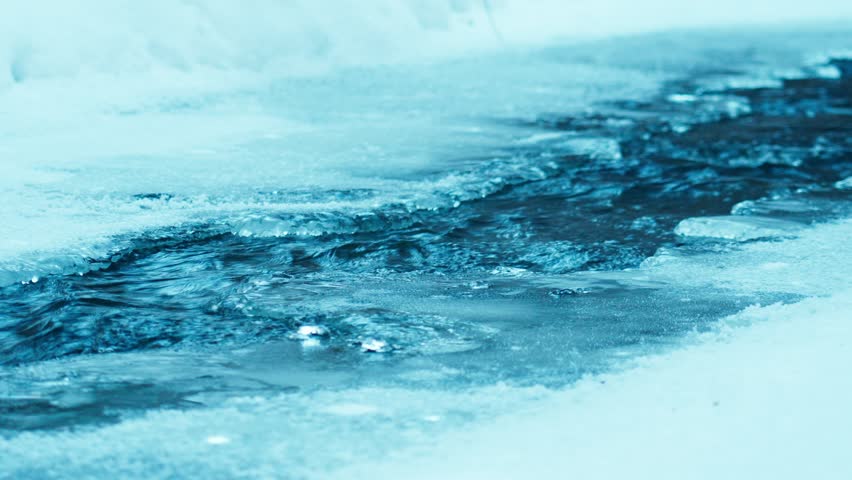 The flow of fresh icy water in a mountain river erodes the ice in winter. Water and ice are harmoniously combined. The surrounding nature relaxes and gives a feeling of peace.