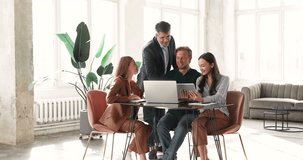 Happy colleagues collaborate around laptop in office, reviewing new business platform or data, sharing ideas, working on joint online project. Team collaboration, group discussion, digital workflow - Powered by Shutterstock - Get 15% off with code: PIKWIZARD15