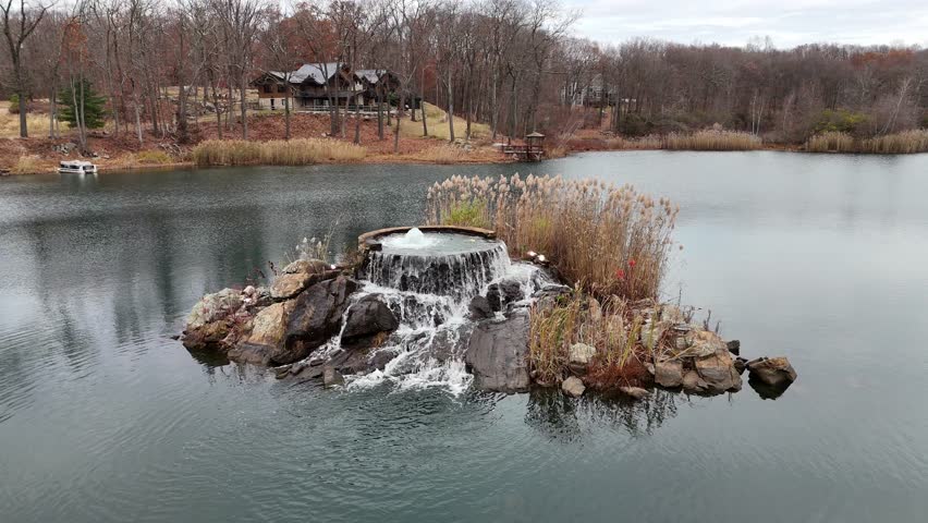 Aerial View of Rock Island Lake Club with Waterfall in the Middle of the Lake