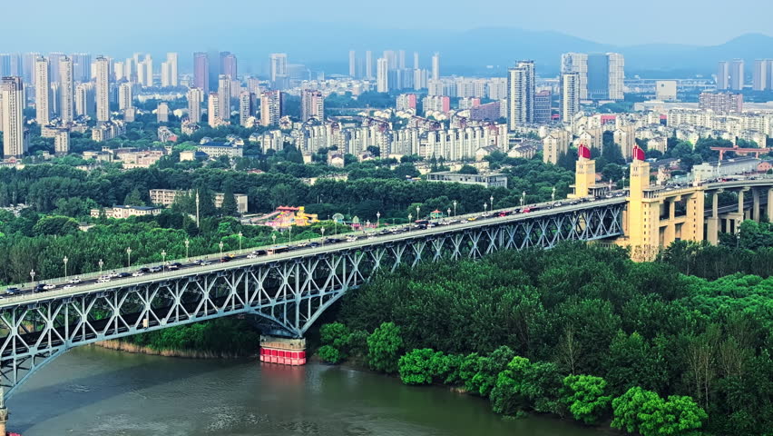 Aerial shot of the Nanjing Yangtze River Bridge carrying heavy traffic over the river in Nanjing, China during the day.