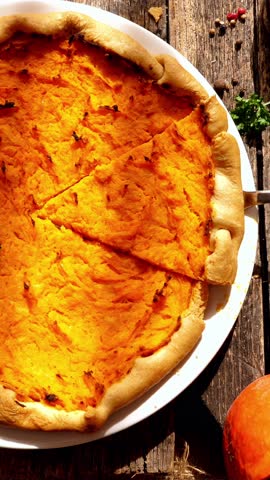 Steaming pumpkin pie on a rustic wooden table. Vertical video for social media content