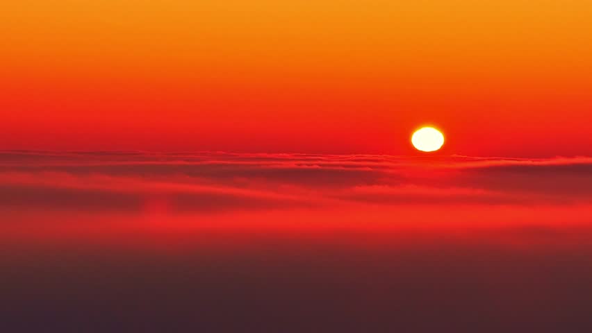 Bright sun sets over calm horizon with warm vibrant colors, serene mood