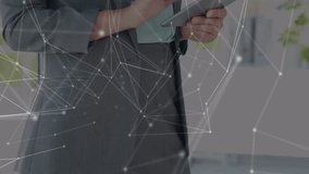 Animation of network of connections over caucasian businesswoman using tablet. global business, technology, networking, connections and digital interface concept digitally generated video. - Powered by Shutterstock - Get 15% off with code: PIKWIZARD15