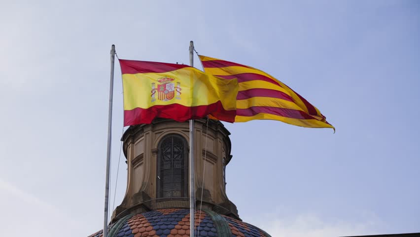 The Spanish flag and the Catalan flag are flying on the administrative building.