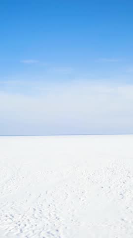 Beautiful winter landscape with fresh snow and ice covering nature under an early morning sky