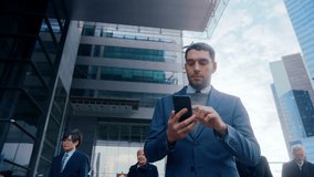 Businessman Activates AI Smartphone While Walking through City Business Center. Hologram Code and Network Symbols Illustrate Wireless Data Flow, Digital Banking, Cloud Services, Secure Messaging - Powered by Shutterstock - Get 15% off with code: PIKWIZARD15