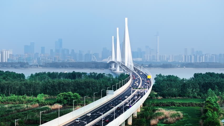 Aerial shot of the modern Nanjing Yangtze River Bridge with traffic crossing over the river in China.