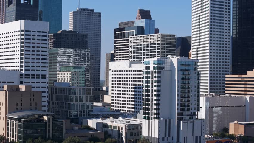Drone flying between Houston high buildings at day time
