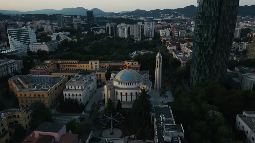 Cityscape view of Tirana, Albania, modern buildings and mountains on the horizon