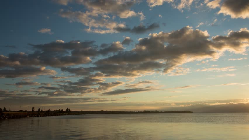 Sunrise over a river with clouds, time-lapse video of early morning sunrise with beautiful sky